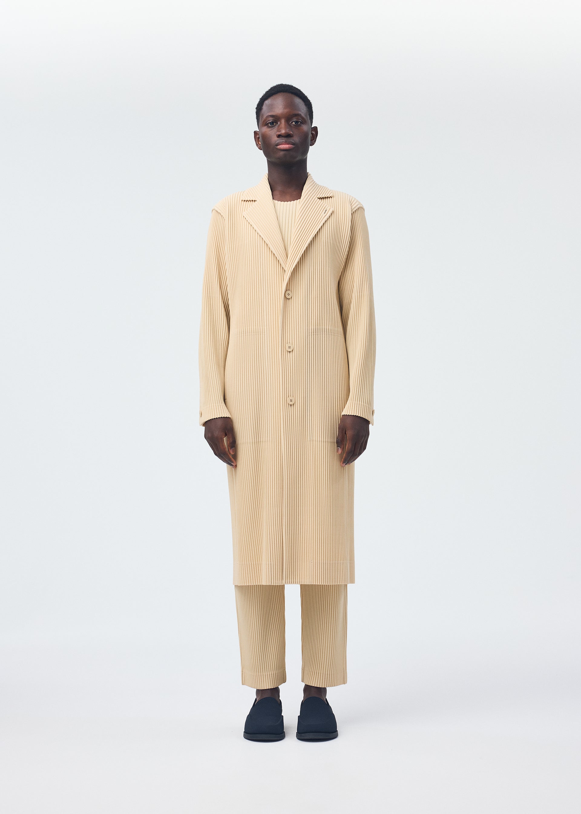 A model wears the Homme Plisse Issey Miyake TAILORED PLEATS 2 jacket.