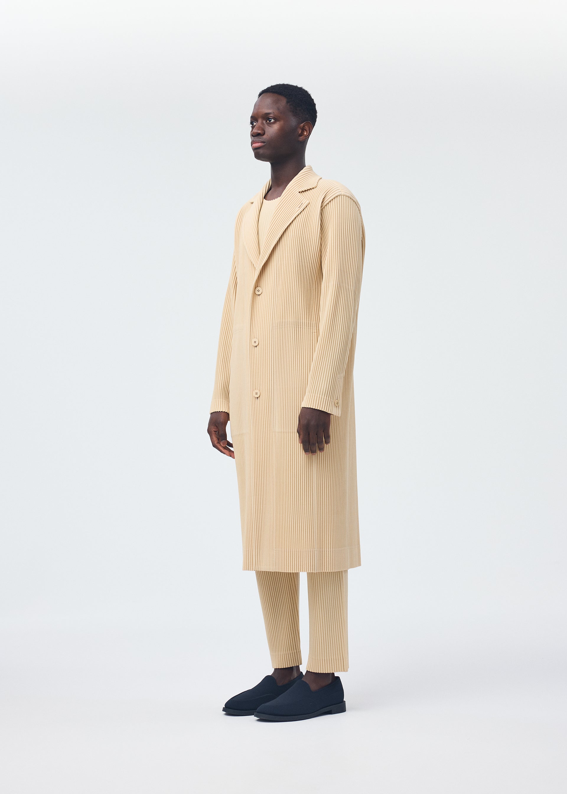 A model wears the Homme Plisse Issey Miyake TAILORED PLEATS 2 jacket.