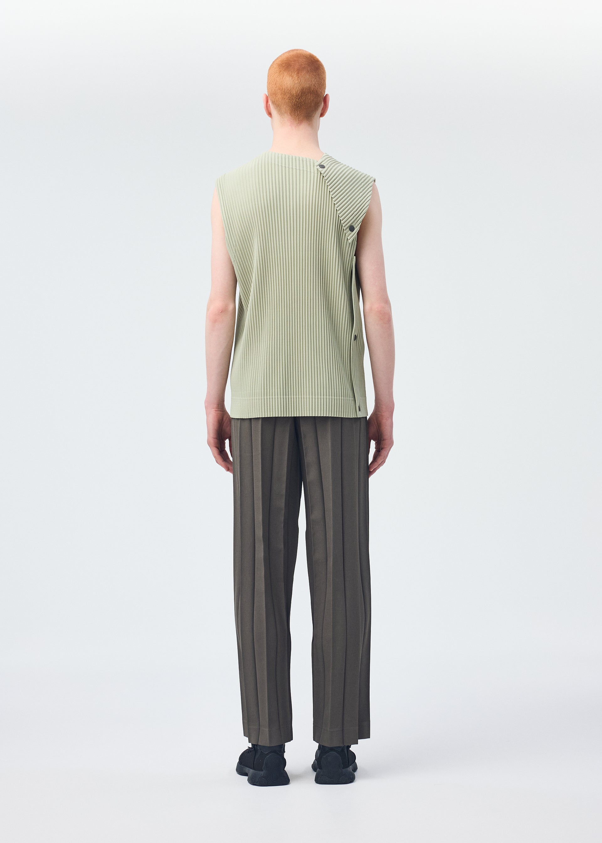 A model wears the HOMME PLISSÉ ISSEY MIYAKE STONE CLOUD vest.