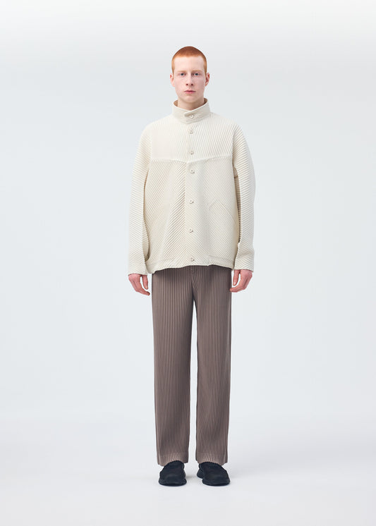 A model wears the Homme Plisse Issey Miyake MONTHLY COLORS : SEPTEMBER trousers.