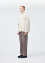 A model wears the Homme Plisse Issey Miyake MONTHLY COLORS : SEPTEMBER trousers.