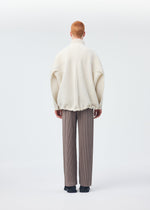 A model wears the Homme Plisse Issey Miyake MONTHLY COLORS : SEPTEMBER trousers.