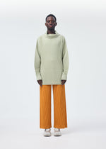 A model wears the Homme Plisse Issey Miyake MONTHLY COLORS : OCTOBER trousers.
