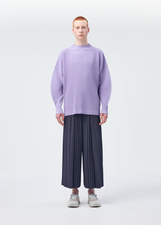 A model wears the Homme Plisse Issey Miyake MONTHLY COLORS : DECEMBER trousers.