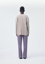 A model wears the HOMME PLISSÉ ISSEY MIYAKE PLEATS BOTTOMS 1 trousers.