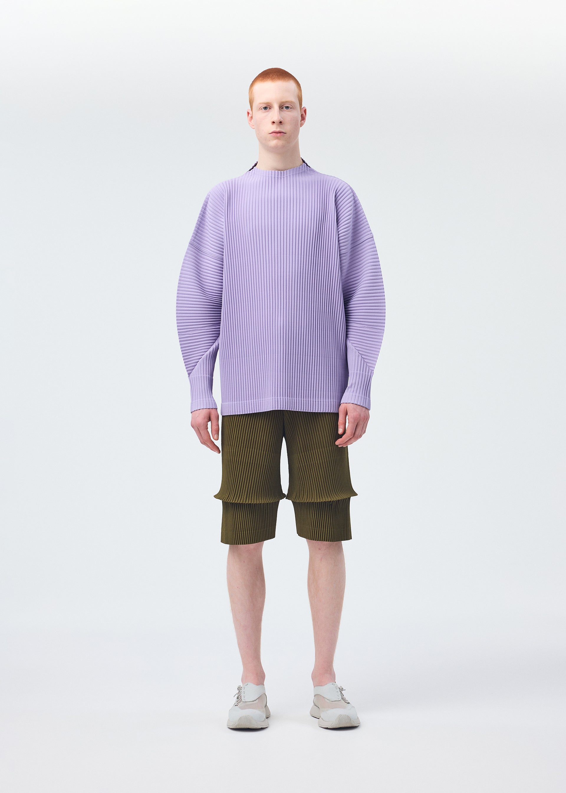 A model wears the Homme Plisse Issey Miyake PLEATS BOTTOMS 2 trousers.