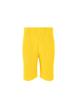 A product shot of the HOMME PLISSÉ ISSEY MIYAKE COLOR PLEATS trousers in citrine yellow (51).