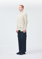 A model wears the HOMME PLISSÉ ISSEY MIYAKE MULTI POCKET trousers.