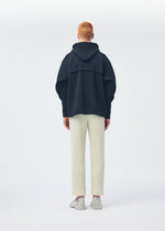 A model wears the Homme Plisse Issey Miyake WICKERWORK MESH trousers.