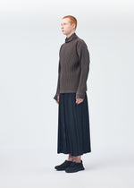 A model wears the Homme Plisse Issey Miyake WICKERWORK MESH trousers.