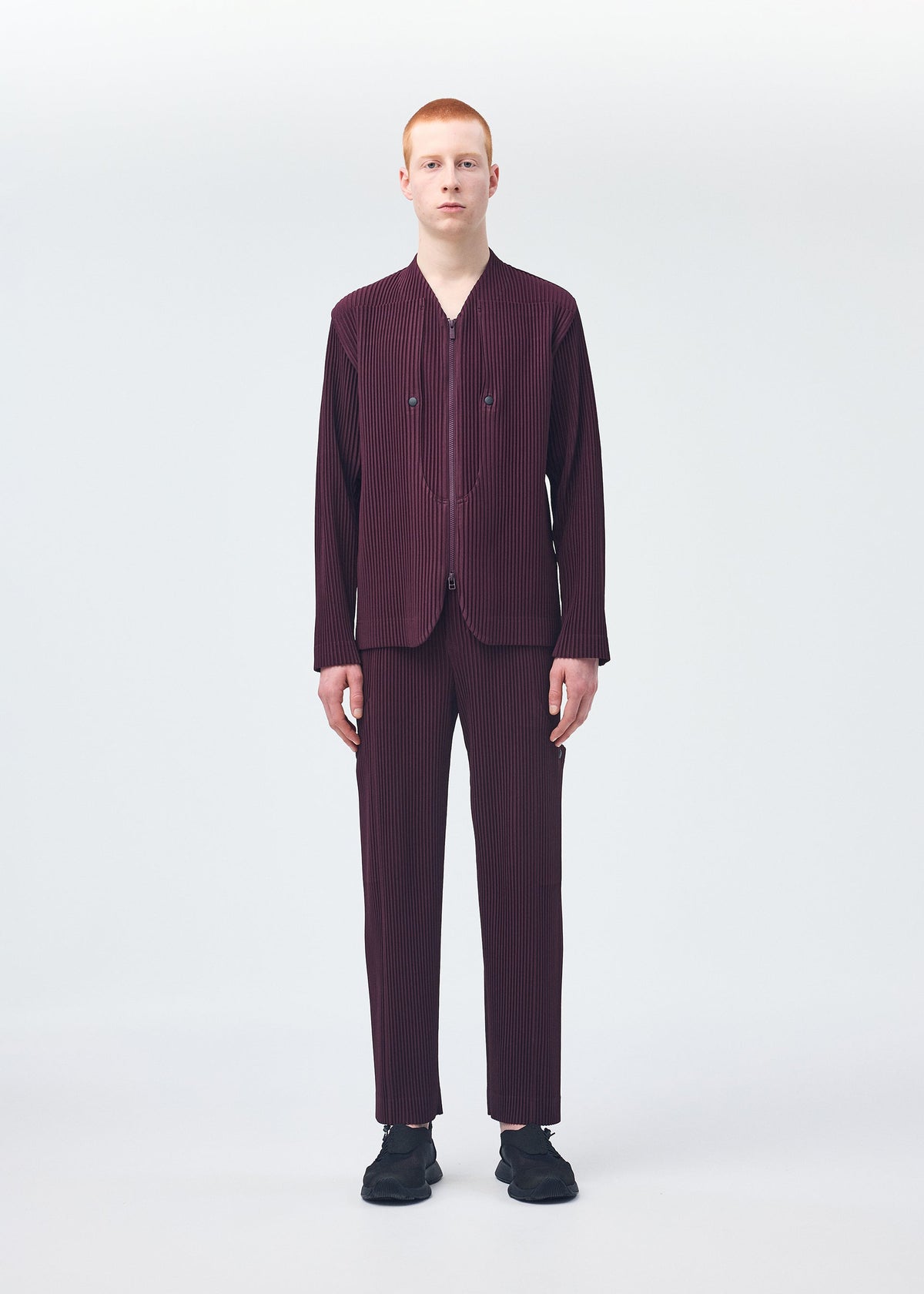 A model wears the Homme Plisse Issey Miyake QUARRY trousers.
