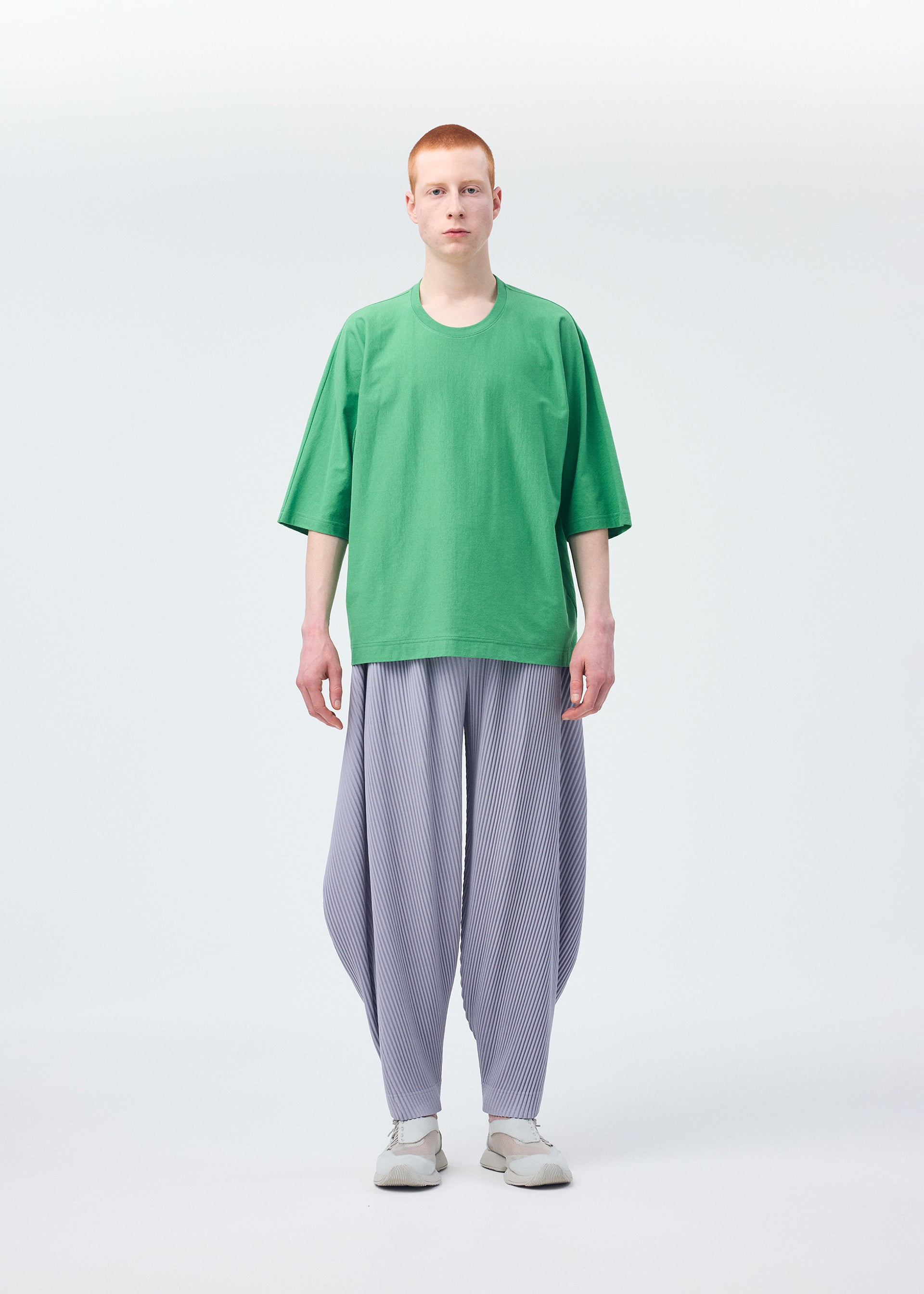 A model wears the Homme Plisse Issey Miyake ANGULAR STONE trousers.