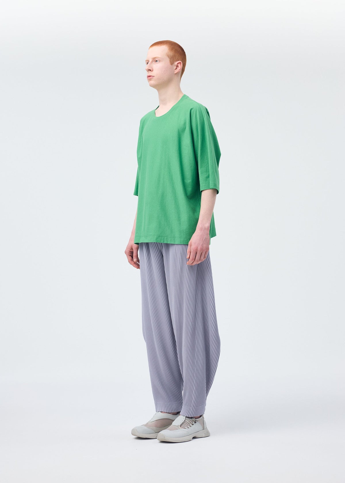 A model wears the Homme Plisse Issey Miyake ANGULAR STONE trousers.