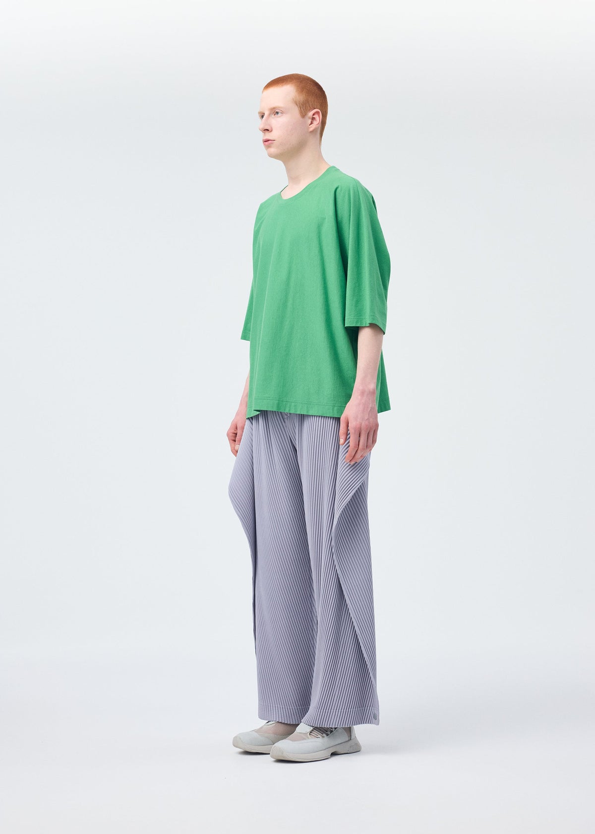 A model wears the Homme Plisse Issey Miyake ANGULAR STONE trousers.