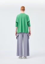 A model wears the Homme Plisse Issey Miyake ANGULAR STONE trousers.