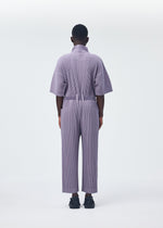 A model wears the HOMME PLISSÉ ISSEY MIYAKE PLEATS BOTTOMS 1 jumpsuit.