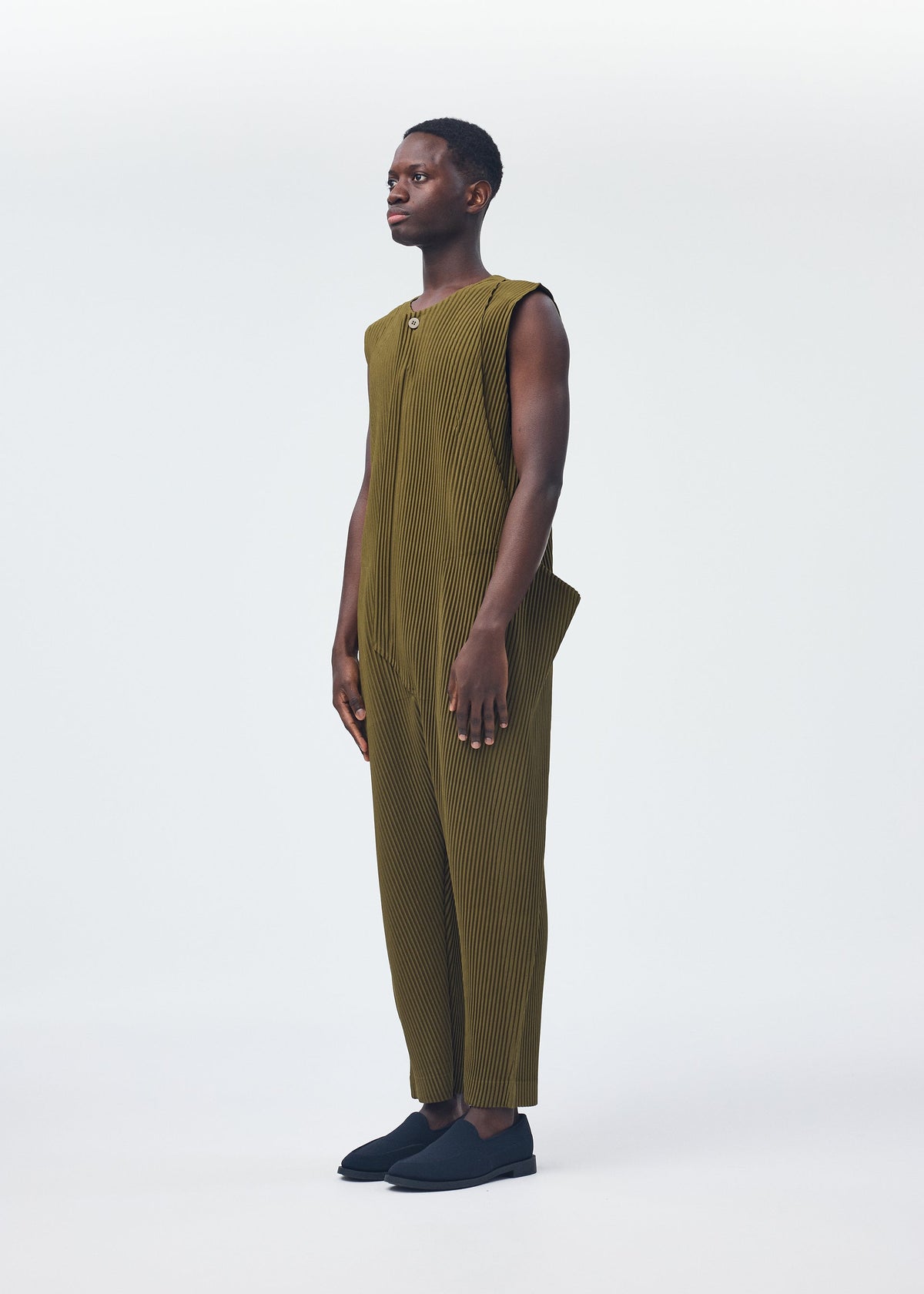 A model wears the Homme Plisse Issey Miyake PLEATS BOTTOMS 2 jumpsuit.