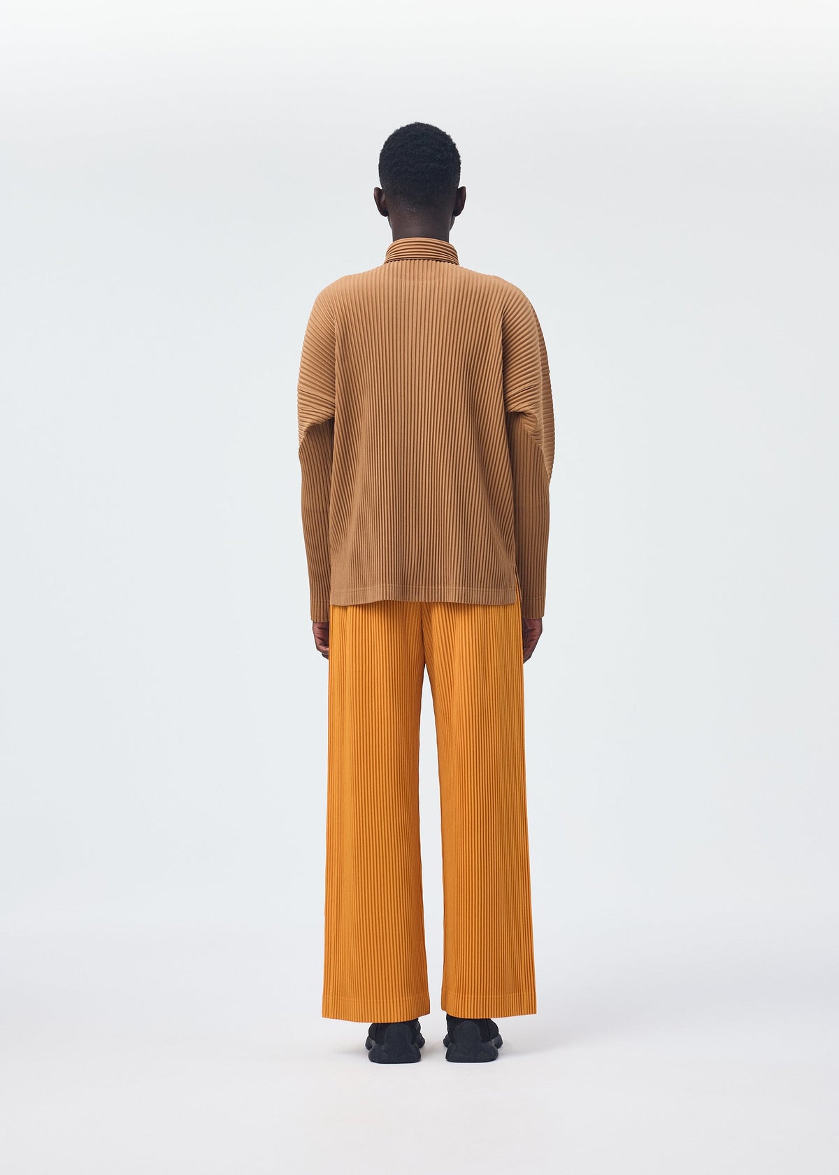 A model wears the Homme Plisse Issey Miyake MONTHLY COLORS : OCTOBER shirt.