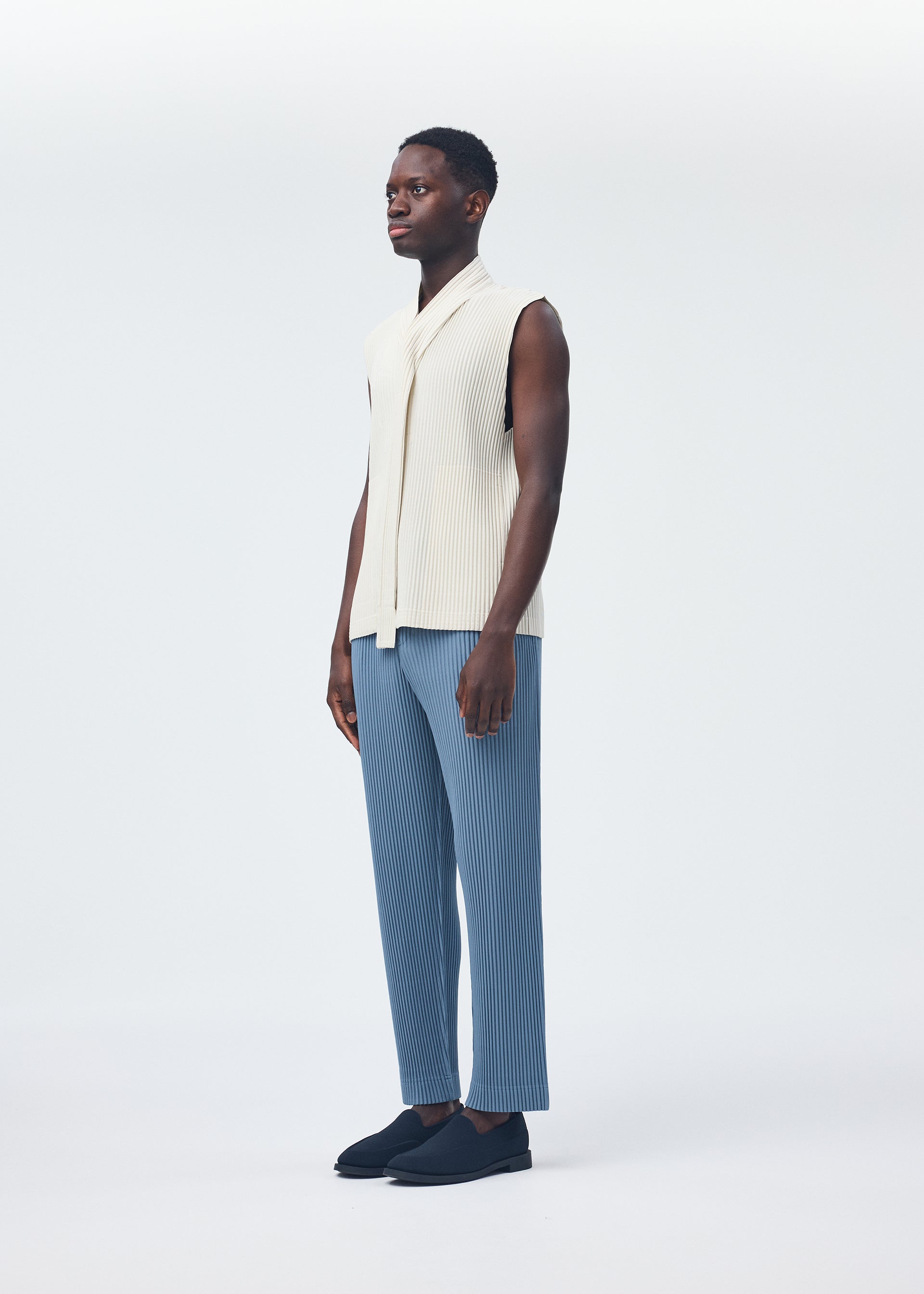 A model wears the Homme Plisse Issey Miyake MONTHLY COLORS : SEPTEMBER top.
