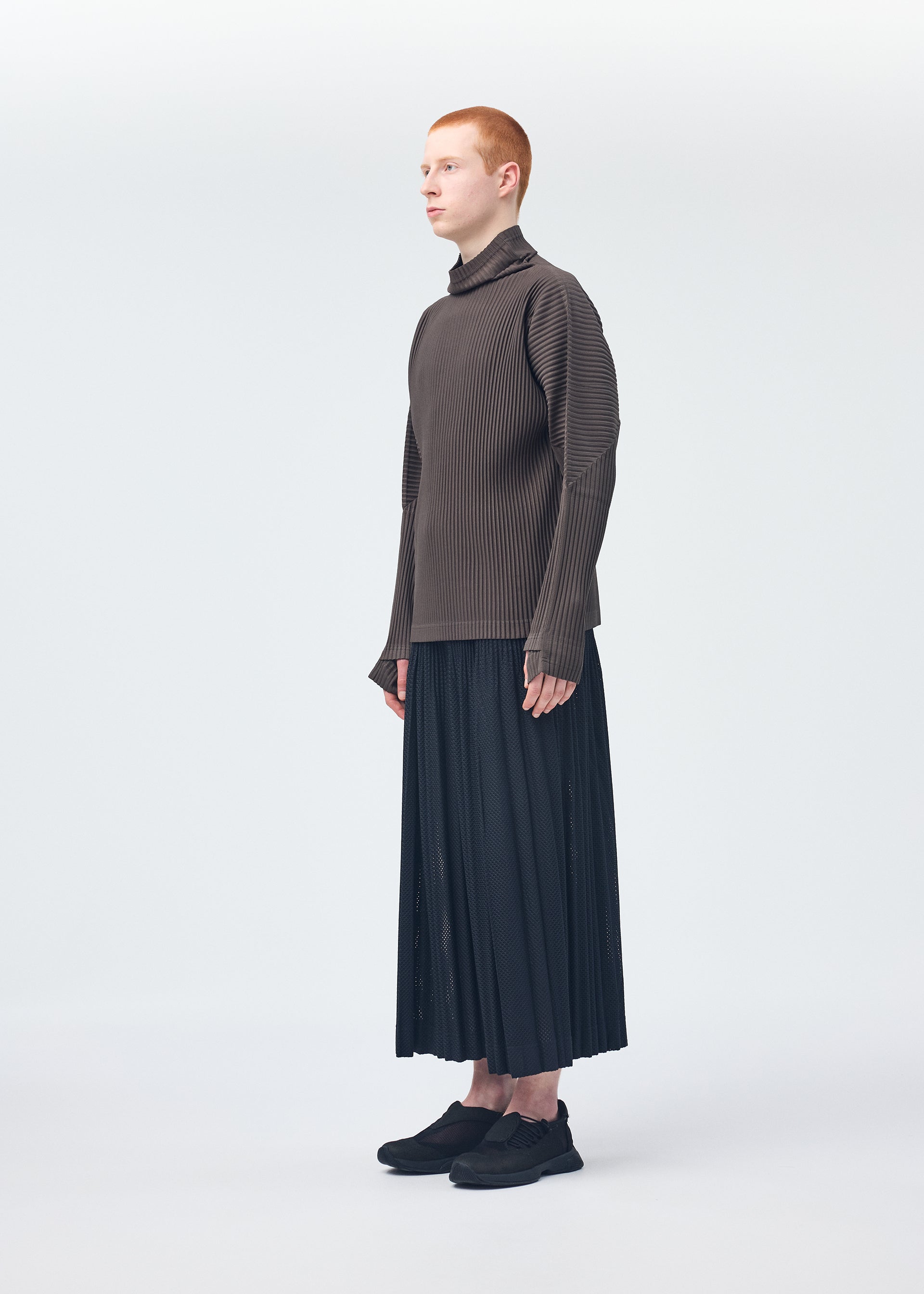 A model wears the Homme Plisse Issey Miyake MONTHLY COLORS : NOVEMBER top.