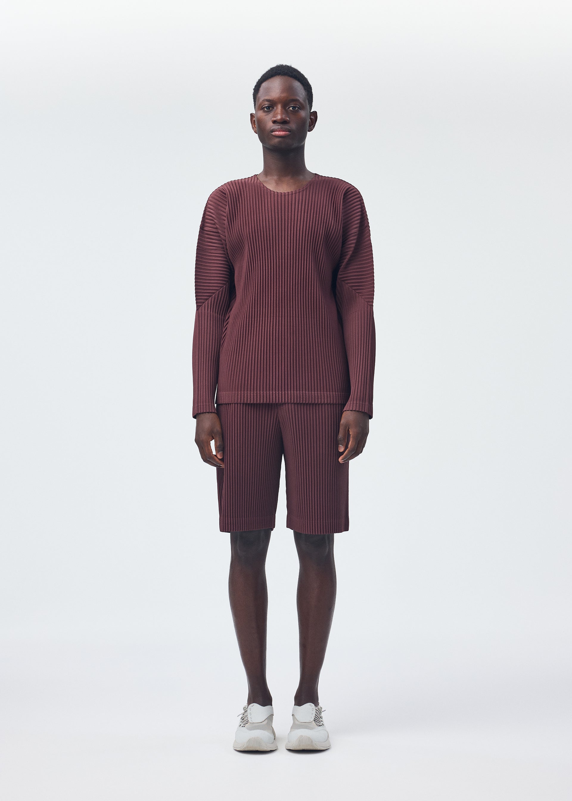 A model wears the HOMME PLISSÉ ISSEY MIYAKE COLOR PLEATS top.