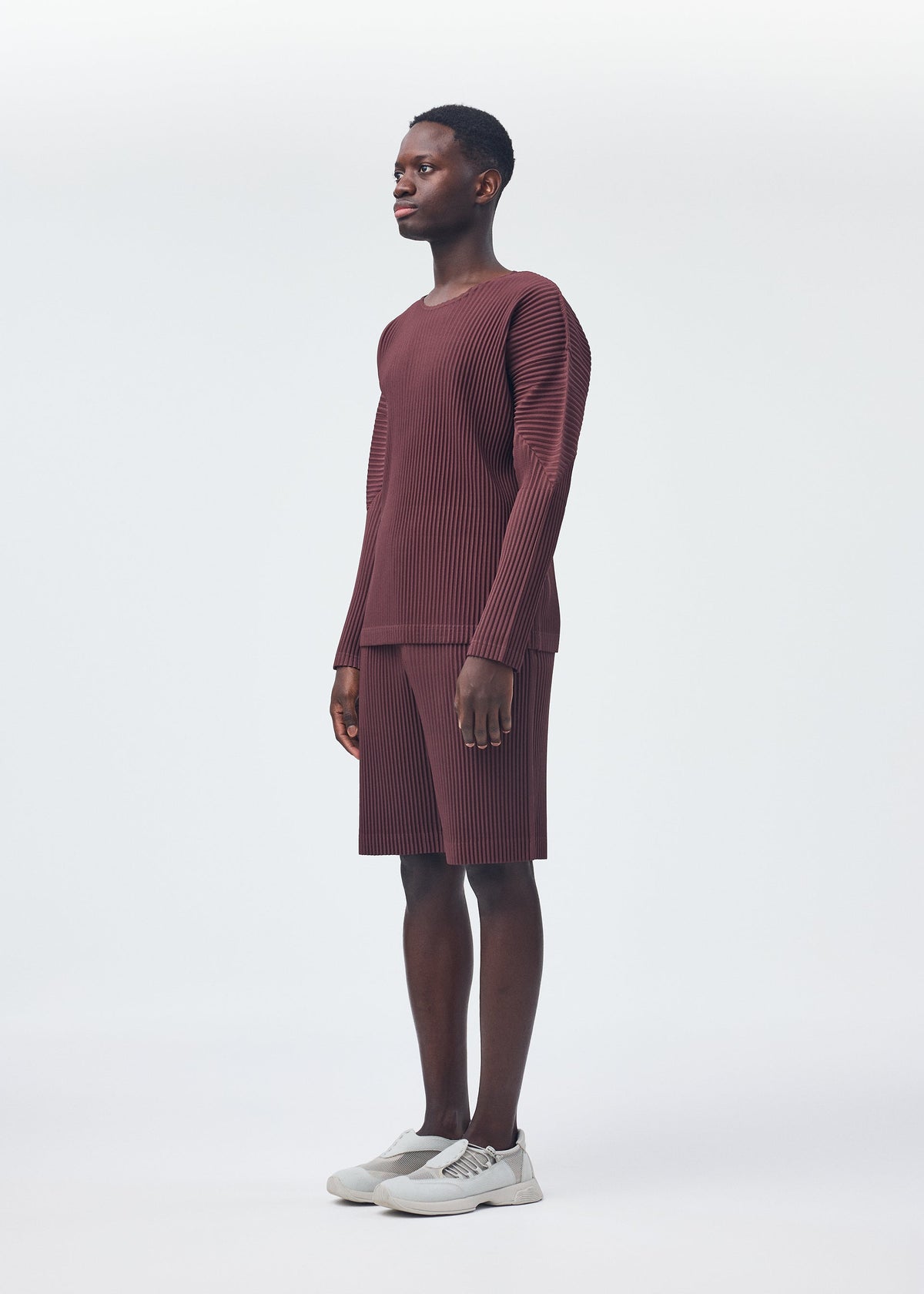 A model wears the HOMME PLISSÉ ISSEY MIYAKE COLOR PLEATS top.