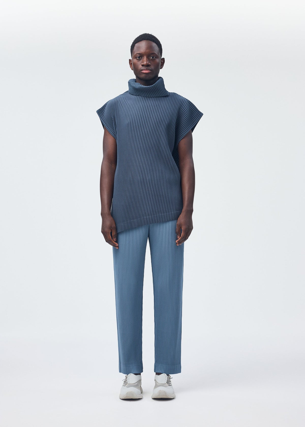 A model wears the Homme Plisse Issey Miyake ANGULAR STONE top.