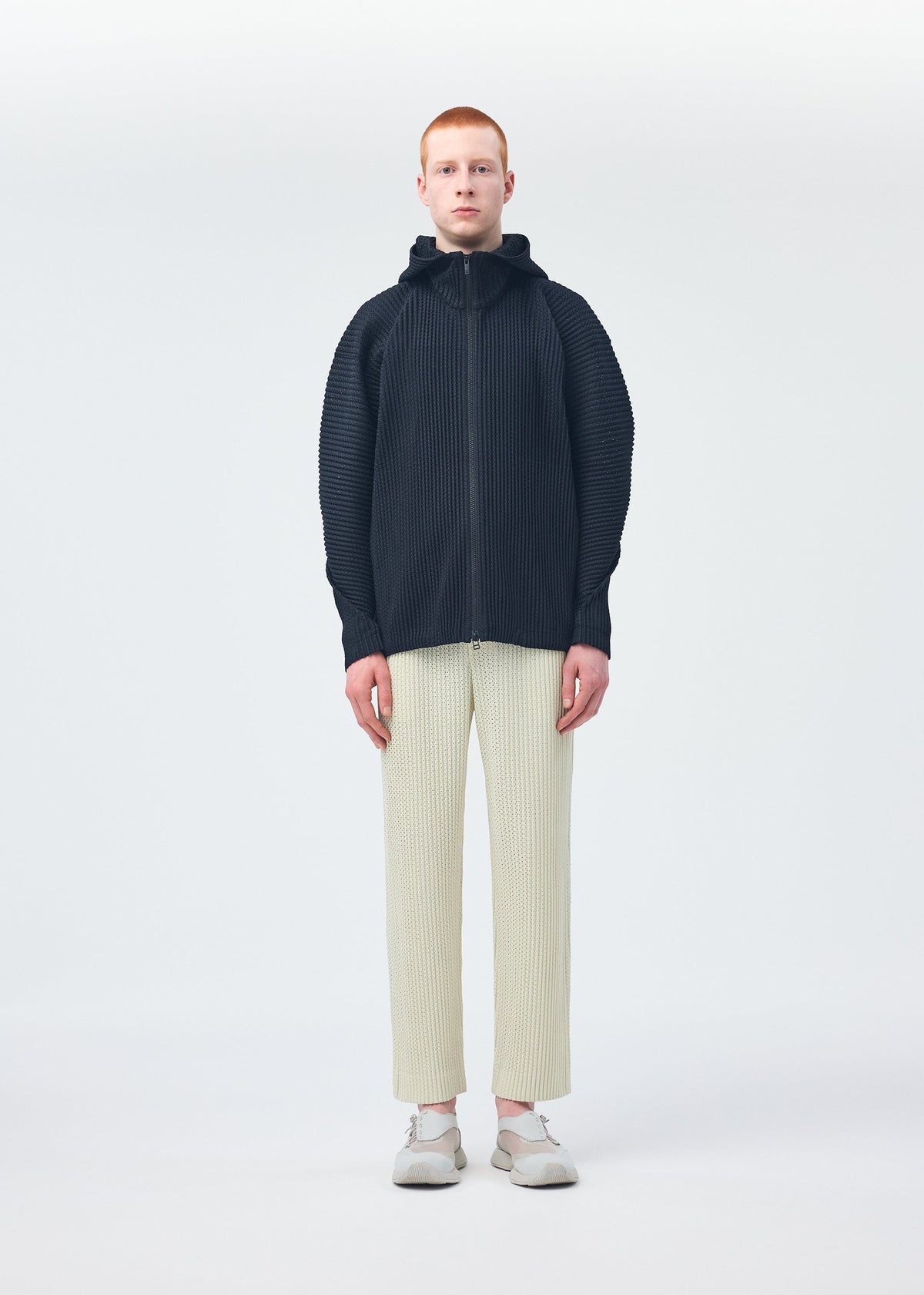 A model wears the Homme Plisse Issey Miyake WICKERWORK MESH blouson.