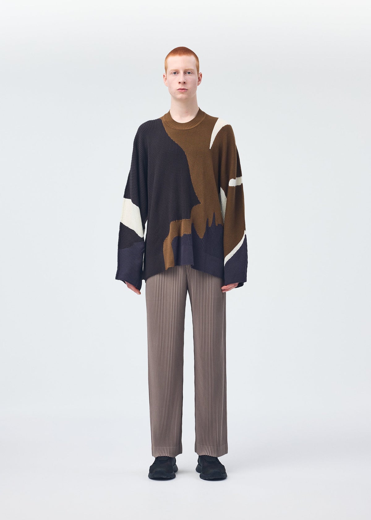 A model wears the Homme Plisse Issey Miyake AGATE KNIT top.