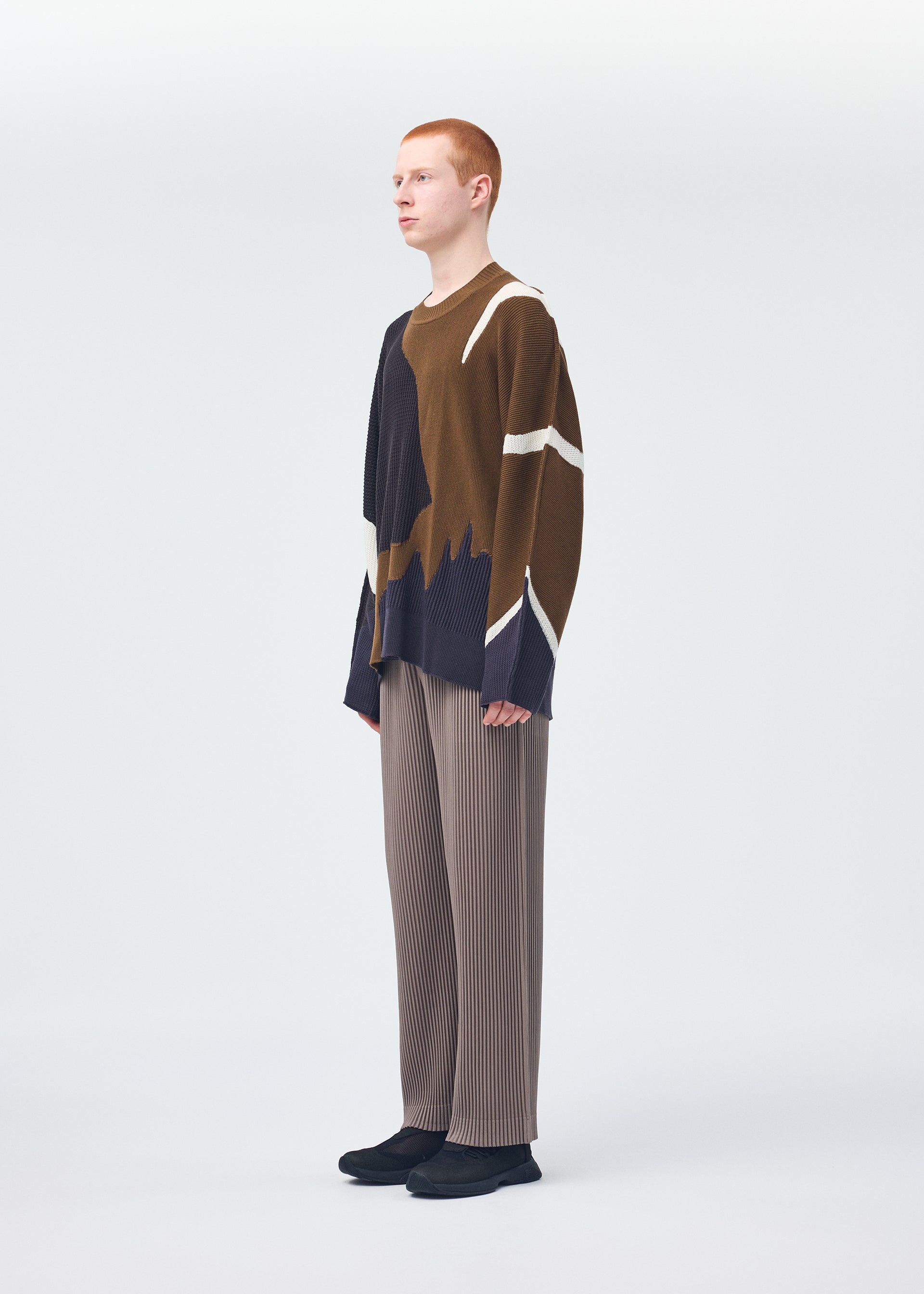 A model wears the Homme Plisse Issey Miyake AGATE KNIT top.