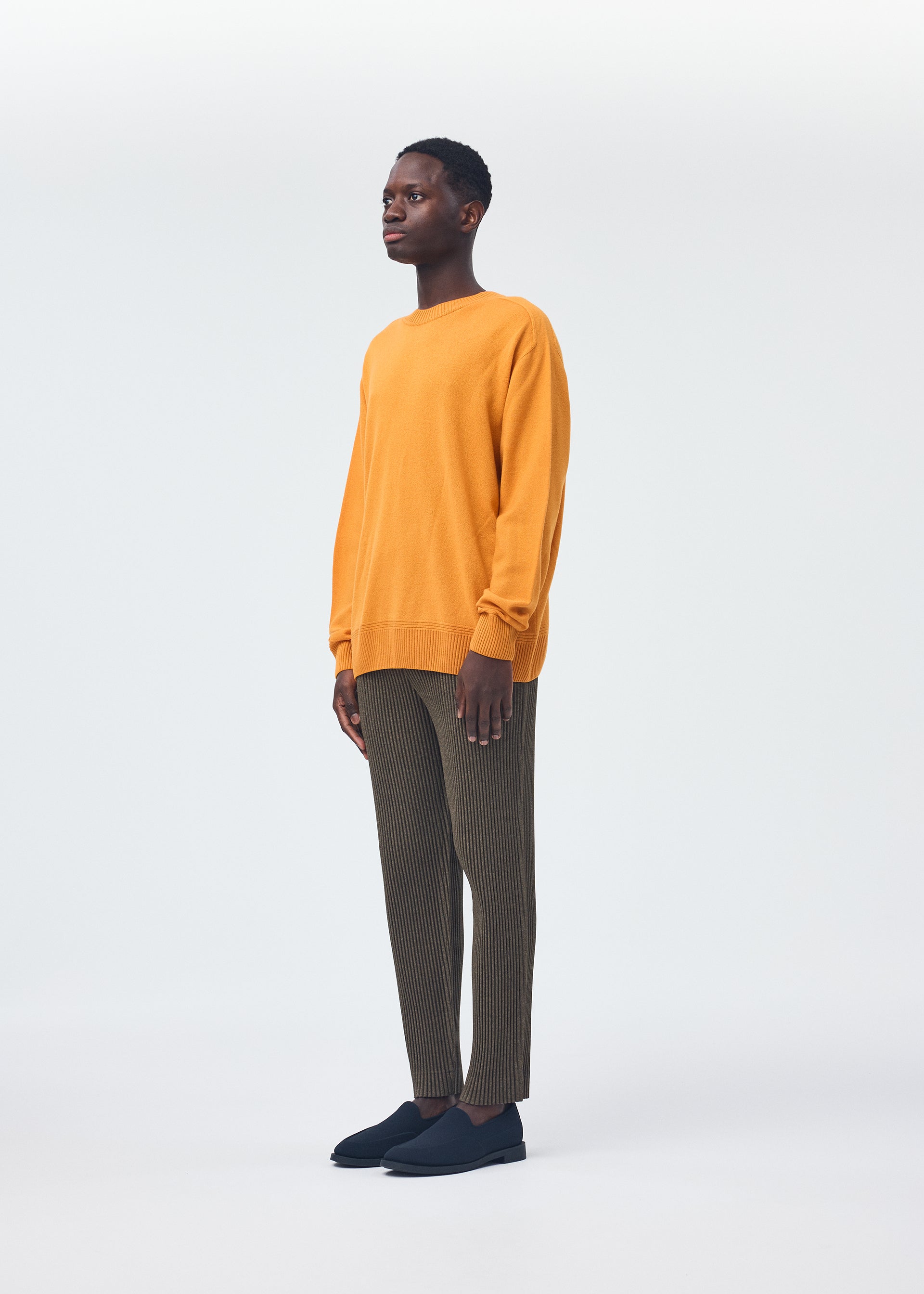 A model wears the Homme Plisse Issey Miyake HP CASHMERE top.
