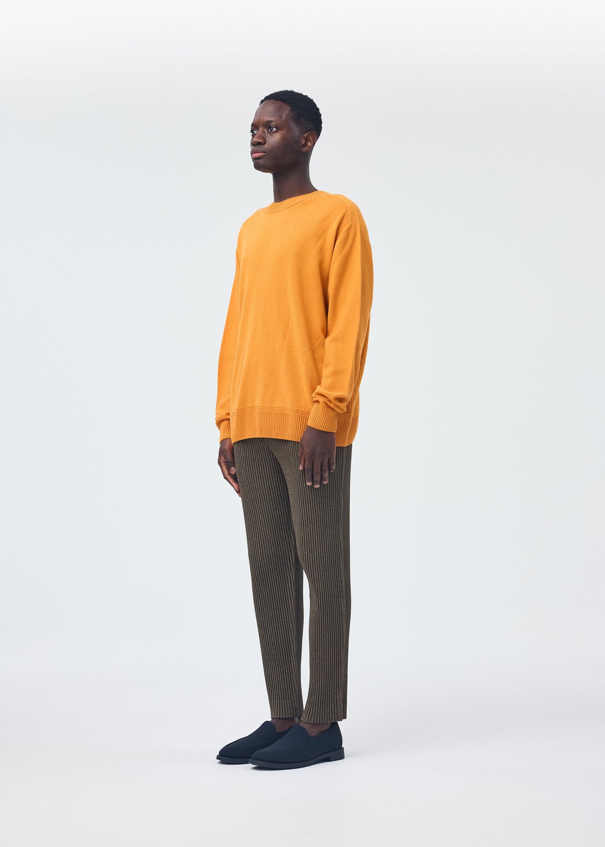 A model wears the Homme Plisse Issey Miyake HP CASHMERE top.
