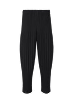A product shot of the HOMME PLISSÉ ISSEY MIYAKE BASICS trousers in black.