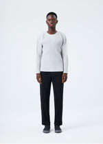 A model wears the HOMME PLISSÉ ISSEY MIYAKE BASICS basics-shirt-black-fw26.