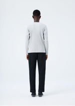A model wears the HOMME PLISSÉ ISSEY MIYAKE BASICS basics-shirt-black-fw26.