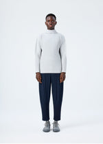 A model wears the HOMME PLISSÉ ISSEY MIYAKE BASICS basics-shirt-black-2-fw26.