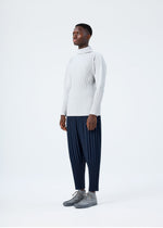 A model wears the HOMME PLISSÉ ISSEY MIYAKE BASICS basics-shirt-black-2-fw26.