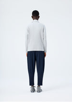 A model wears the HOMME PLISSÉ ISSEY MIYAKE BASICS basics-shirt-black-2-fw26.