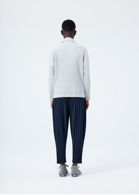 A model wears the HOMME PLISSÉ ISSEY MIYAKE BASICS basics-shirt-black-2-fw26.