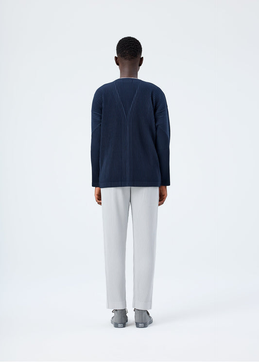 A model wears the HOMME PLISSÉ ISSEY MIYAKE BASICS basics-cardigan-light-grey-fw26.