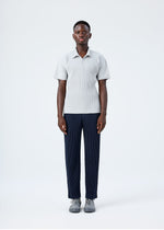 A model wears the HOMME PLISSÉ ISSEY MIYAKE BASICS basics-polo-shirt-navy-1.