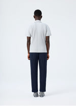 A model wears the HOMME PLISSÉ ISSEY MIYAKE BASICS basics-polo-shirt-black-fw26.