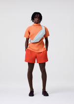 A model wears the Homme Plisse Issey Miyake VERSATILE CROSSBODY bag.