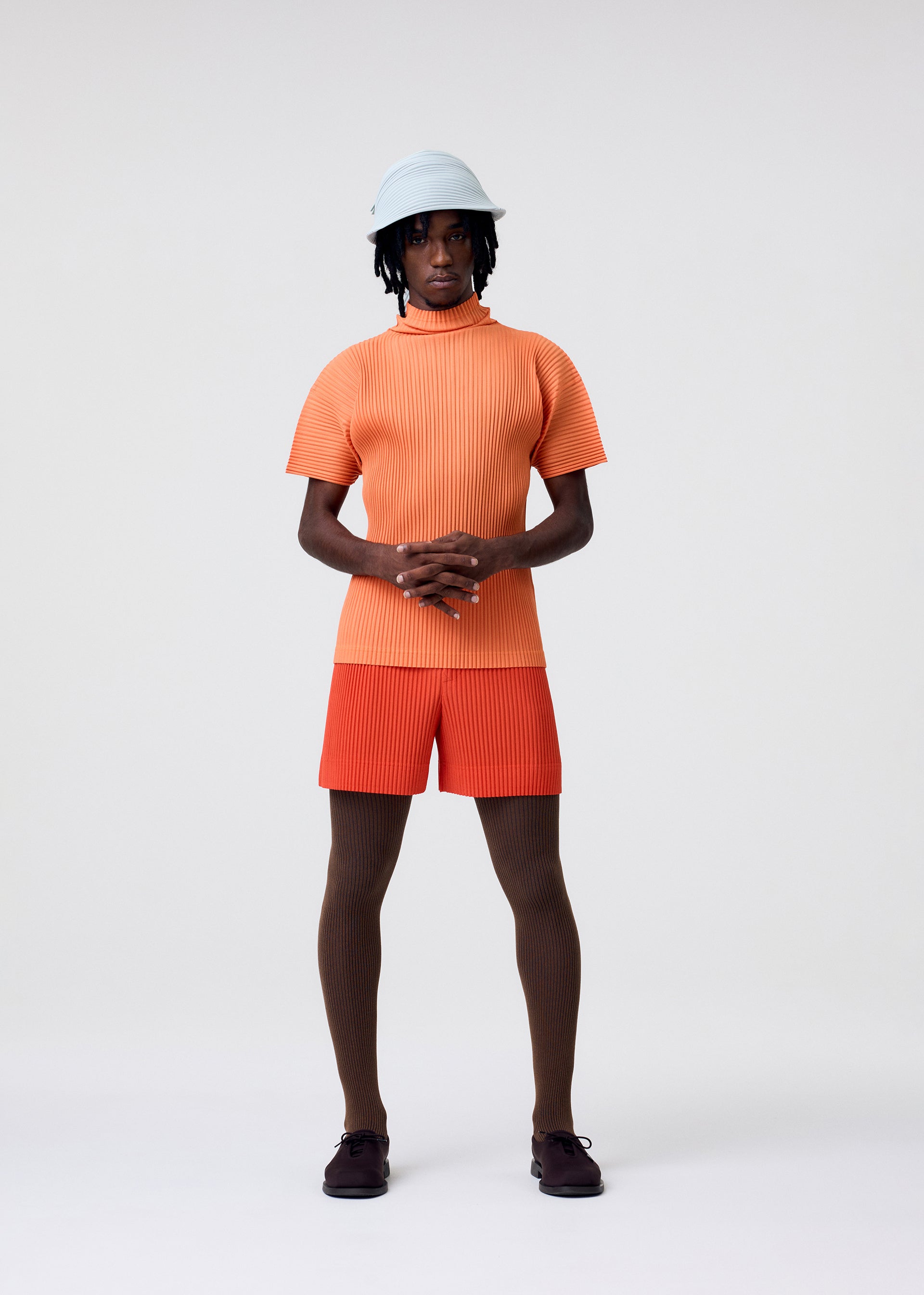 A model wears the Homme Plisse Issey Miyake VERSATILE CROSSBODY bag.