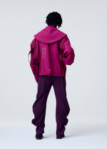 A model wears the HOMME PLISSE ISSEY MIYAKE CARRIER CARRIED prêt à porter.