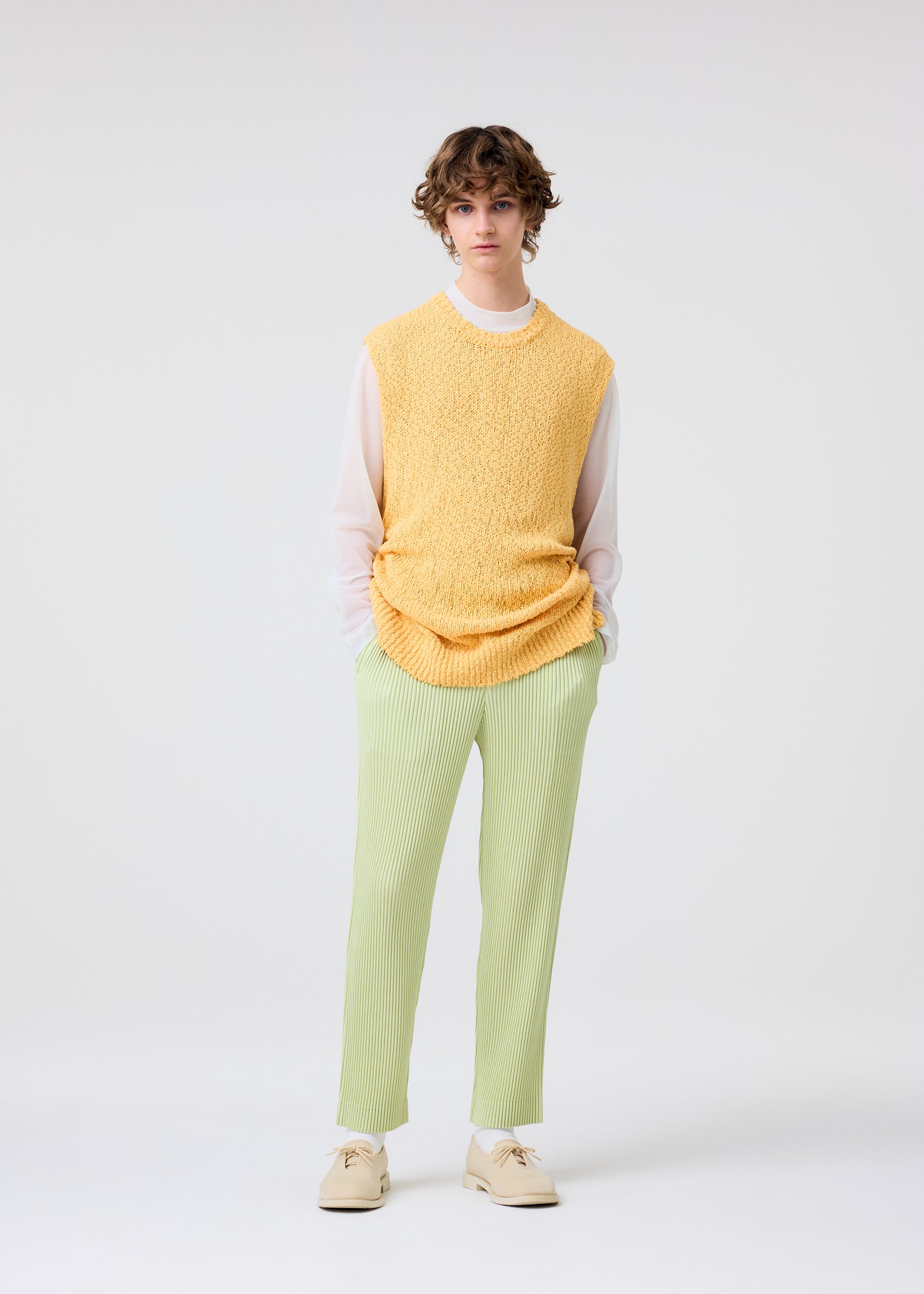 A model wears the Homme Plisse Issey Miyake LINEN LIKE trousers.