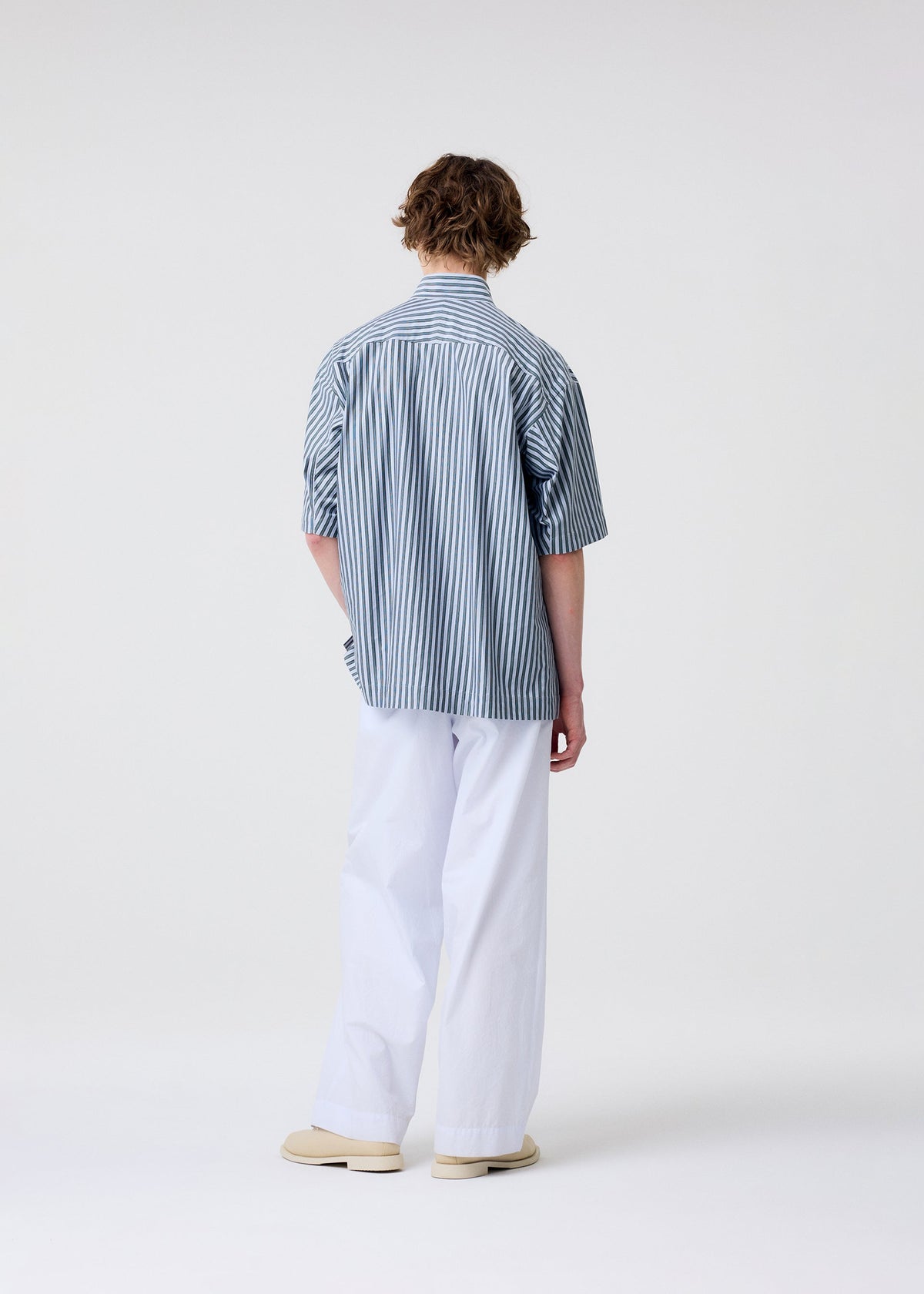 A model wears the Homme Plisse Issey Miyake FRESHEN pants.