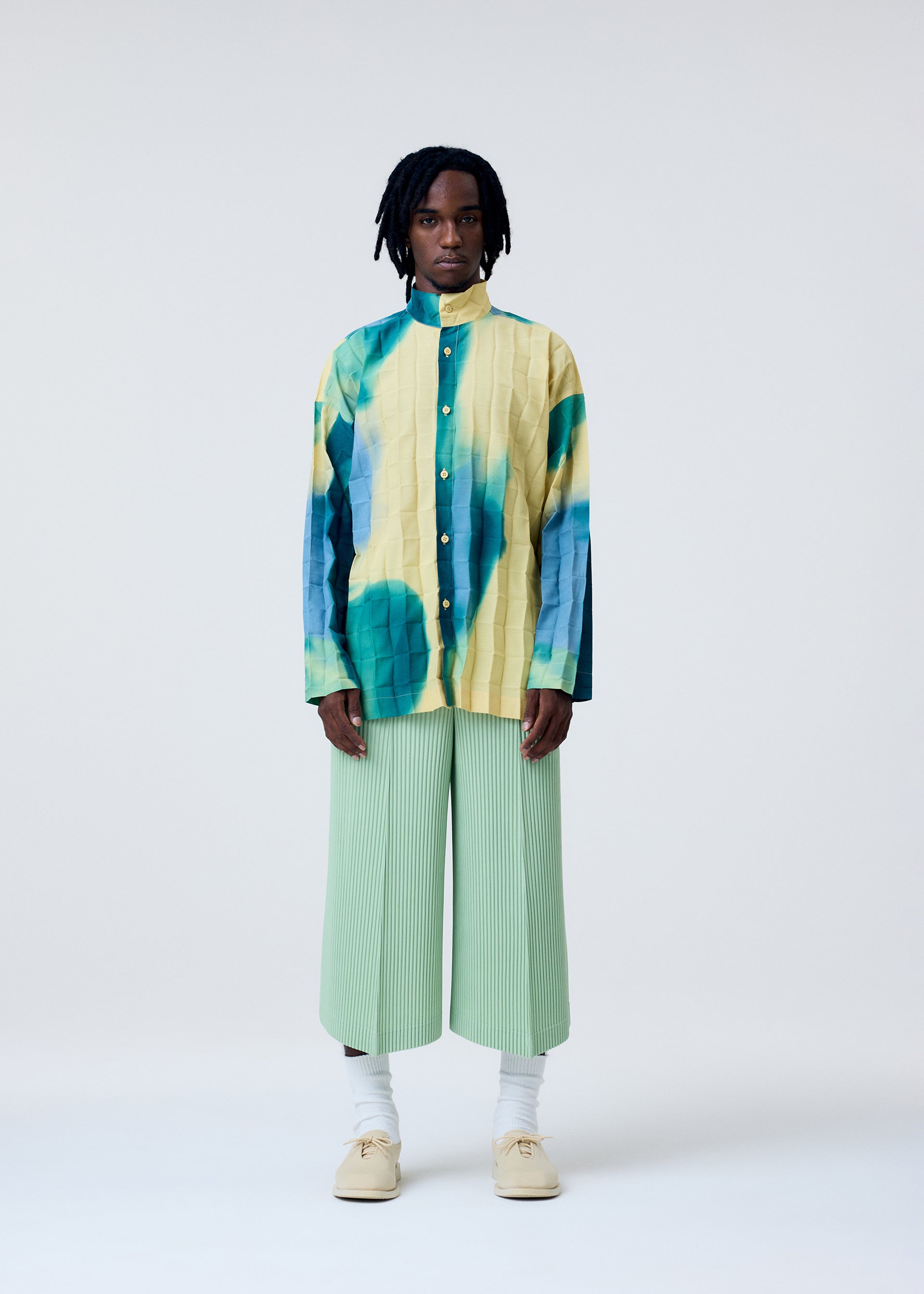 A model wears the Homme Plisse Issey Miyake DAWN EDGE SHIRT shirt.