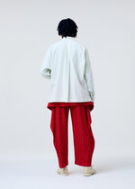 A model wears the HOMME PLISSE ISSEY MIYAKE STREAMLINE SHIRT prêt à porter.