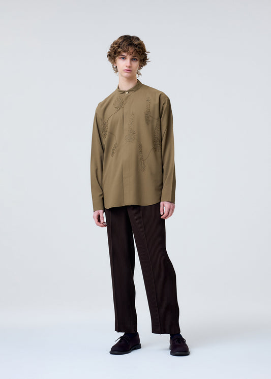 A model wears the Homme Plisse Issey Miyake EMBROIDERY PRESS SHIRT prêt à porter.